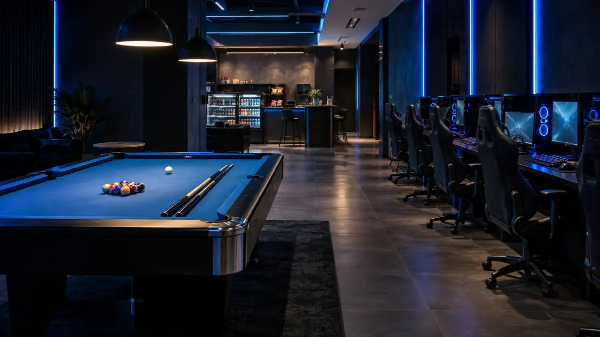 A blue-felt pool table with balls and cues in a contemporary gaming venue